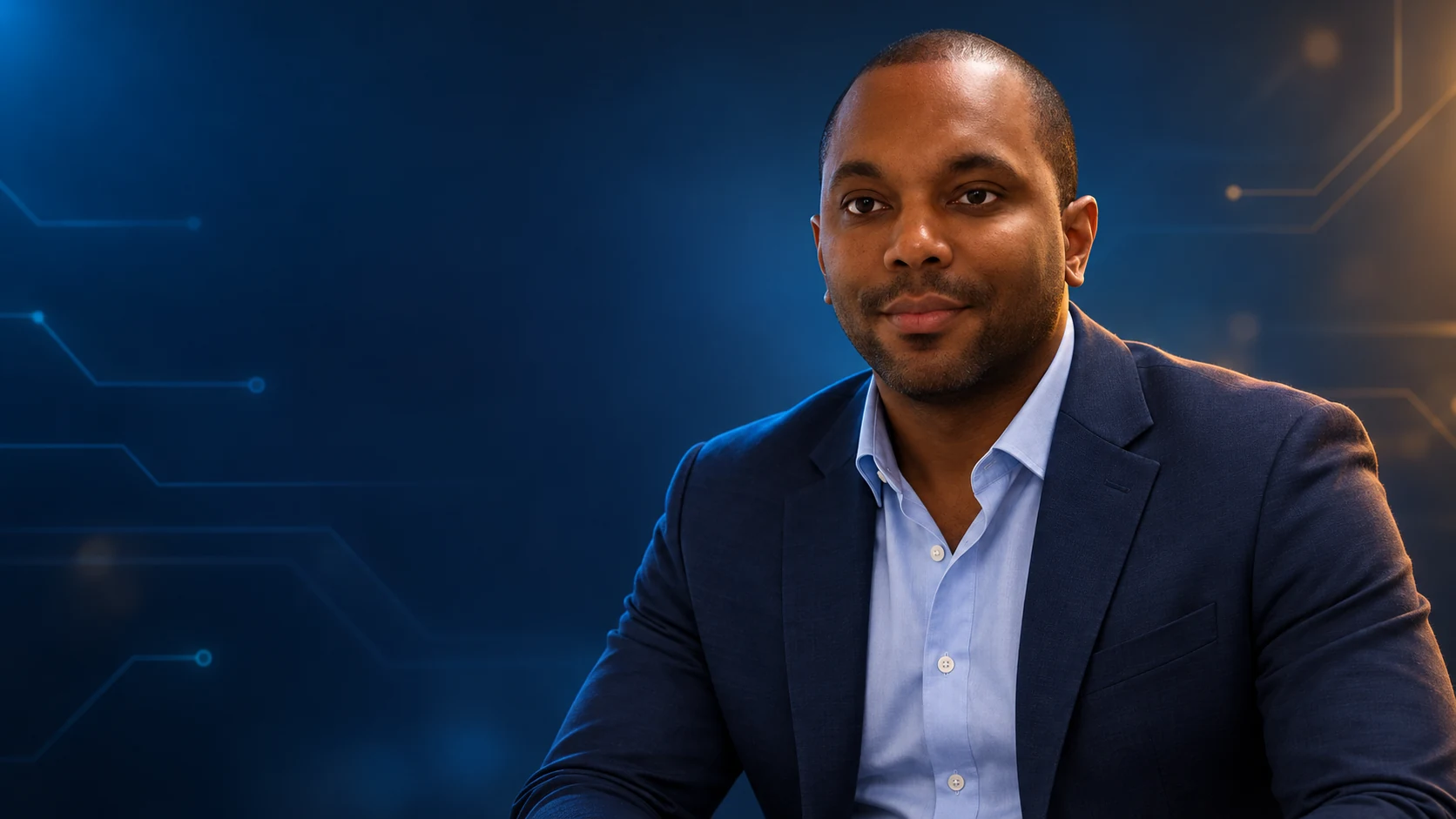 Eric Pollard, seated in a navy suit against a blue digital backdrop